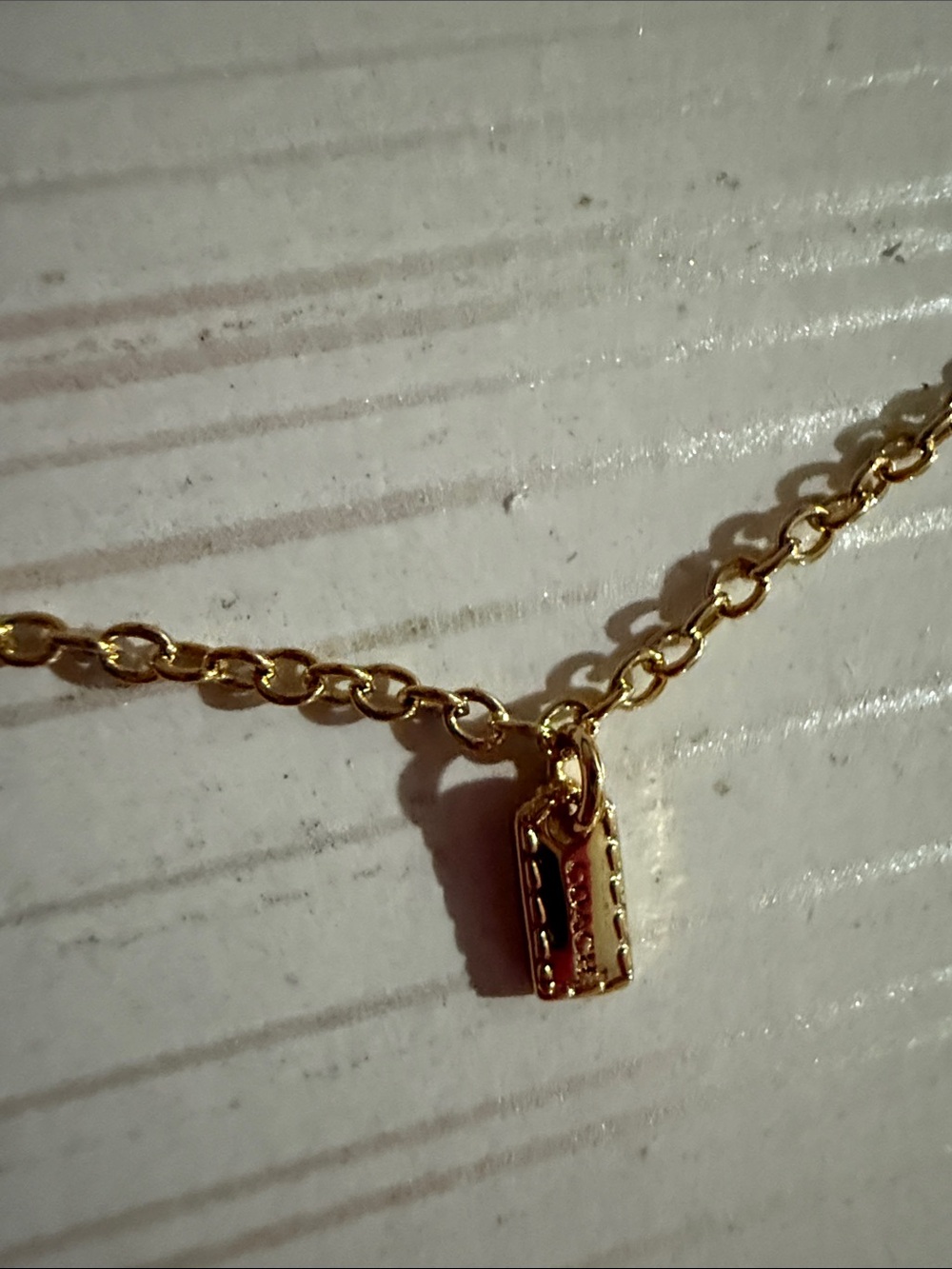 This is a Coach Mini Icons gold-tone charm bracelet. NWT $128 - Picture 4 of 6
